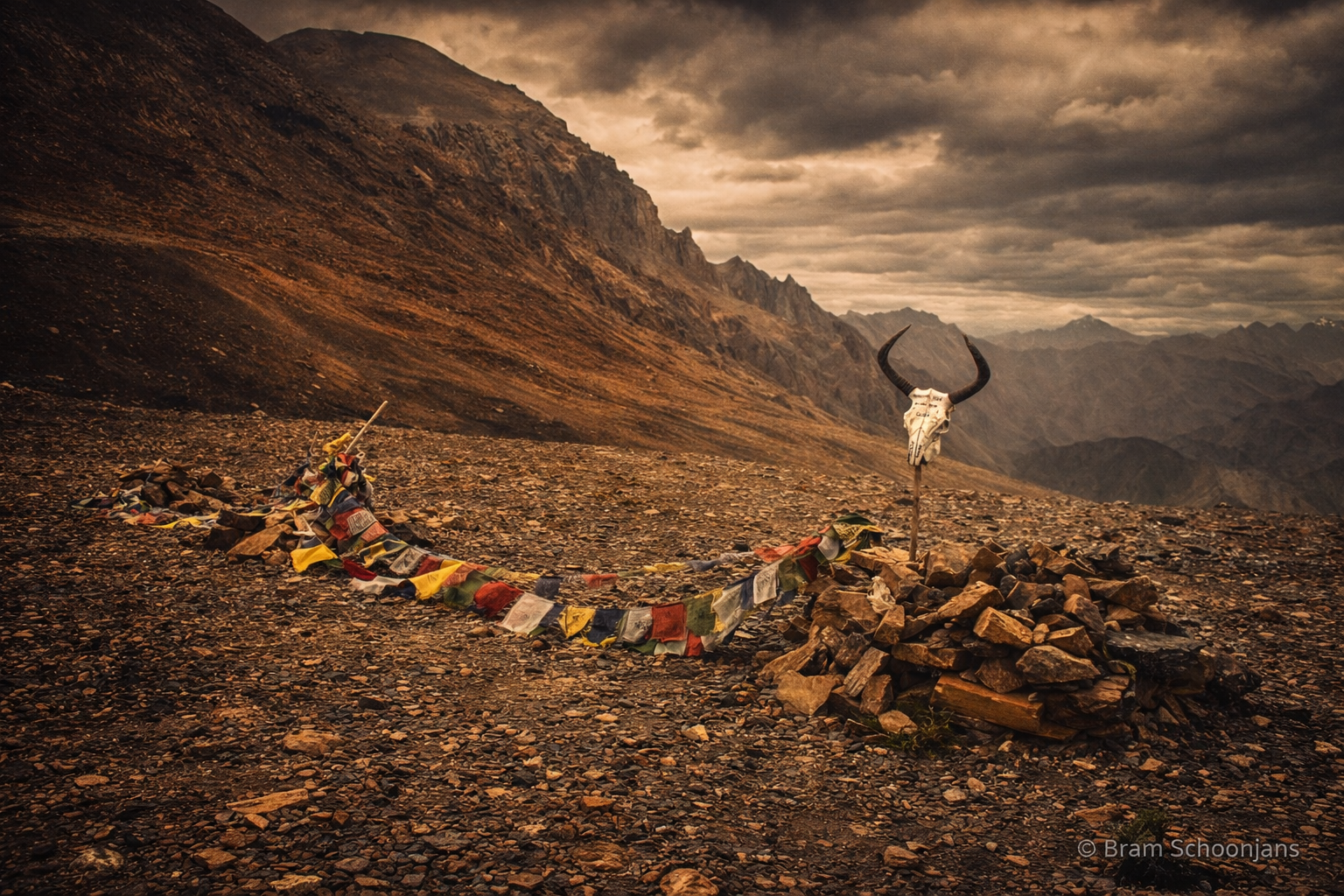 High mountain pass with prayer flags and wide Himalayan views