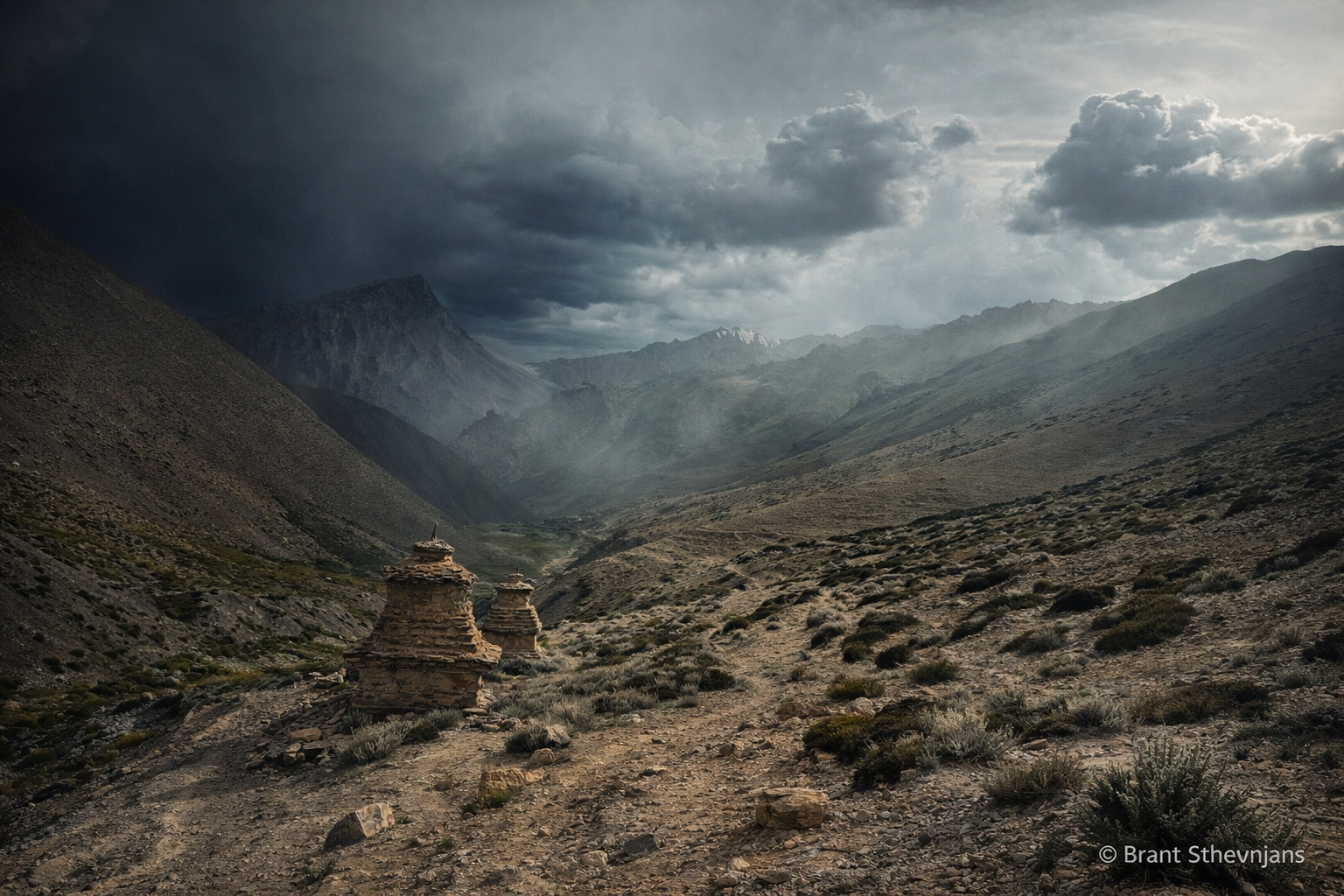 Mountain trail with stupa and dramatic clouds on the fifth day of the trek